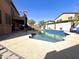 Backyard area showing the pool area, patio, and lush landscaping for relaxation and recreation at 17420 W Mohave St, Goodyear, AZ 85338