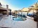 Gorgeous backyard pool with rock waterfalls surrounded by palm trees and comfortable seating area at 17420 W Mohave St, Goodyear, AZ 85338