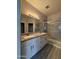 Bright bathroom featuring a double vanity with granite counters, tiled floors, and glass shower enclosure at 1743 W Pollack St, Phoenix, AZ 85041