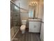 View of a gray and white bathroom featuring a glass shower and granite vanity top with ample counterspace at 1743 W Pollack St, Phoenix, AZ 85041