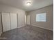 Bedroom featuring gray carpet, a window, and closet with sliding doors at 1743 W Pollack St, Phoenix, AZ 85041