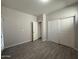 View of a light gray bedroom featuring plank flooring and double closets with bi-fold doors at 1743 W Pollack St, Phoenix, AZ 85041