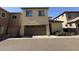 View of a beige two-story home with a brown garage door and minimal landscaping at 1743 W Pollack St, Phoenix, AZ 85041