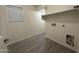 Bright laundry room with tile flooring, shelf, and utility connections at 1743 W Pollack St, Phoenix, AZ 85041