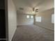 Expansive living room with neutral carpet and a ceiling fan at 1743 W Pollack St, Phoenix, AZ 85041