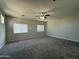 Bright living room with gray carpet and a ceiling fan at 1743 W Pollack St, Phoenix, AZ 85041