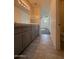 Bathroom features a granite double sink vanity and large mirror with tile flooring and a doorway into another room at 1745 W Pollack St, Phoenix, AZ 85041