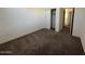 Bedroom with neutral carpeting and walk-in closet, well lit by overhead lighting at 1745 W Pollack St, Phoenix, AZ 85041