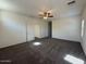 Large bedroom with plush carpet and ceiling fan transitions to the next room through a bright white doorway at 1745 W Pollack St, Phoenix, AZ 85041