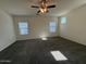 Spacious bedroom featuring plush carpeting, a ceiling fan, and plenty of natural light from multiple windows at 1745 W Pollack St, Phoenix, AZ 85041