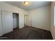 Bright bedroom with a closet and neutral colored walls and carpeting at 1745 W Pollack St, Phoenix, AZ 85041