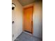 Close up of the front door with a peep hole, door knob and framed by neutral walls at 1745 W Pollack St, Phoenix, AZ 85041