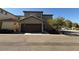 View of a tan two-story home with a two car garage and a small tree in the front yard at 1745 W Pollack St, Phoenix, AZ 85041