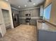 Modern kitchen featuring gray cabinets, stainless steel appliances, granite counters and tile floors at 1745 W Pollack St, Phoenix, AZ 85041