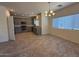 Spacious open floor plan with kitchen featuring stainless steel appliances and a chandelier in the dining area at 1745 W Pollack St, Phoenix, AZ 85041