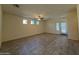 Bright living room with tile floors, a ceiling fan, multiple windows, and a glass panel door at 1745 W Pollack St, Phoenix, AZ 85041