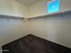 Walk-in closet with carpet, shelving and clothes racks; offers ample storage and organization solutions at 1745 W Pollack St, Phoenix, AZ 85041