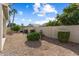 Backyard featuring desert landscaping, manicured shrubs, and block wall fence at 17813 W Primrose Ln, Surprise, AZ 85374