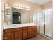 Bathroom featuring double vanity, tiled floors, and glass shower enclosure at 17813 W Primrose Ln, Surprise, AZ 85374