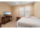 This bedroom features carpet, flatscreen television, and window with blinds at 17813 W Primrose Ln, Surprise, AZ 85374