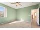 Spacious bedroom with carpet, ceiling fan and a large window at 17813 W Primrose Ln, Surprise, AZ 85374