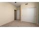 Bedroom features neutral walls, carpet, and closet with double doors at 17813 W Primrose Ln, Surprise, AZ 85374