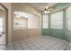 Bright breakfast nook with tiled floors, a ceiling fan, and large sunny windows at 17813 W Primrose Ln, Surprise, AZ 85374