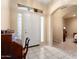 Inviting foyer with tiled flooring and a decorative glass window at 17813 W Primrose Ln, Surprise, AZ 85374