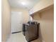 This laundry room includes a pair of modern, front-loading washer and dryer at 17813 W Primrose Ln, Surprise, AZ 85374