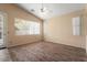 Neutral toned living room with ceiling fan and bright windows at 17813 W Primrose Ln, Surprise, AZ 85374