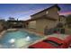 Aerial view of backyard with pool, spa, outdoor kitchen, and covered patio, perfect for entertaining at 18256 W Carol Ave, Waddell, AZ 85355