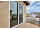 View from balcony with sliding glass doors and view of other homes at 18256 W Carol Ave, Waddell, AZ 85355