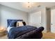 Comfortable bedroom showcasing a luxurious blue bed, soft lighting, and a mirrored closet at 18256 W Carol Ave, Waddell, AZ 85355