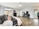 Primary bedroom with wood floors and sliding glass door to balcony at 18256 W Carol Ave, Waddell, AZ 85355