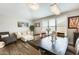 Formal dining room featuring a decorative light fixture, artwork, and large windows at 18256 W Carol Ave, Waddell, AZ 85355