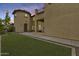 Beautiful stucco home with a turret feature and well-maintained lawn at twilight at 18256 W Carol Ave, Waddell, AZ 85355