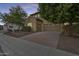 Inviting home with a three-car garage, a brick driveway, and manicured landscaping at 18256 W Carol Ave, Waddell, AZ 85355