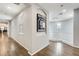 Bright hallway with wood floors, archways, and natural light from windows on the upper level landing at 18256 W Carol Ave, Waddell, AZ 85355