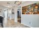 Hallway with arched openings, tile flooring, and decorative art at 18256 W Carol Ave, Waddell, AZ 85355