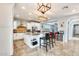 Well-lit kitchen with an island, seating, and stainless steel appliances at 18256 W Carol Ave, Waddell, AZ 85355