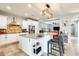 Kitchen with an island and stools, stainless steel appliances, and tile floors at 18256 W Carol Ave, Waddell, AZ 85355