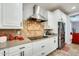 Modern kitchen with stainless steel appliances, granite countertops, and white cabinetry at 18256 W Carol Ave, Waddell, AZ 85355