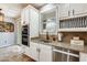 Bright kitchen with stainless steel appliances, granite countertops, and white cabinetry at 18256 W Carol Ave, Waddell, AZ 85355