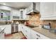 Modern kitchen with stainless steel appliances, granite countertops, and white cabinetry at 18256 W Carol Ave, Waddell, AZ 85355