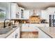 Modern kitchen with stainless steel appliances, granite countertops, and white cabinetry at 18256 W Carol Ave, Waddell, AZ 85355