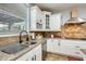 Modern kitchen with stainless steel appliances, granite countertops, and white cabinetry at 18256 W Carol Ave, Waddell, AZ 85355