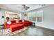 Inviting living room with red sofa, area rug, and view to the updated kitchen at 18256 W Carol Ave, Waddell, AZ 85355