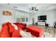 Comfortable living room with a red sectional sofa and modern furnishings at 18256 W Carol Ave, Waddell, AZ 85355