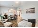 Open-concept living room, including a dining area and arched doorway at 18256 W Carol Ave, Waddell, AZ 85355