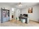 Bright office with a gray desk, matching bookshelf, and a view into the adjacent bathroom at 18256 W Carol Ave, Waddell, AZ 85355